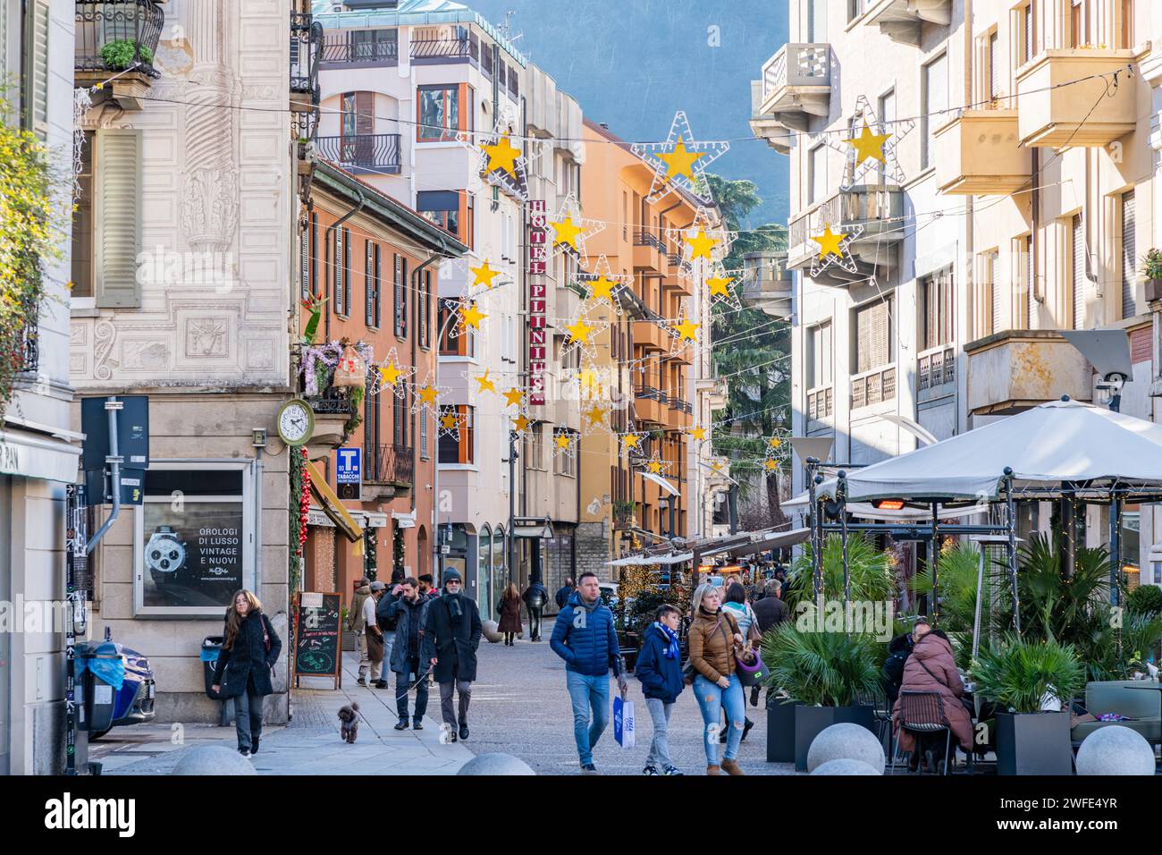People / Tourists walking through a street in the city of Como, Italy Stock Photo