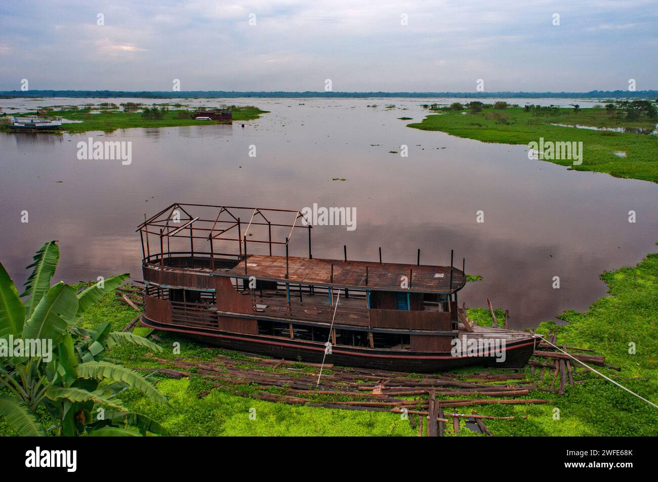 Wooden boats in the Amazon River, Iquitos, Loreto, Peru, South America.  It is surrounded by the Port of Iquitos, formed by the Amazon, Nanay and Itay Stock Photo