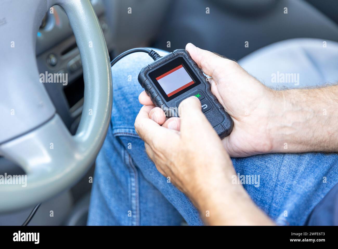 Using diagnostic car code reader to erase error codes Stock Photo - Alamy