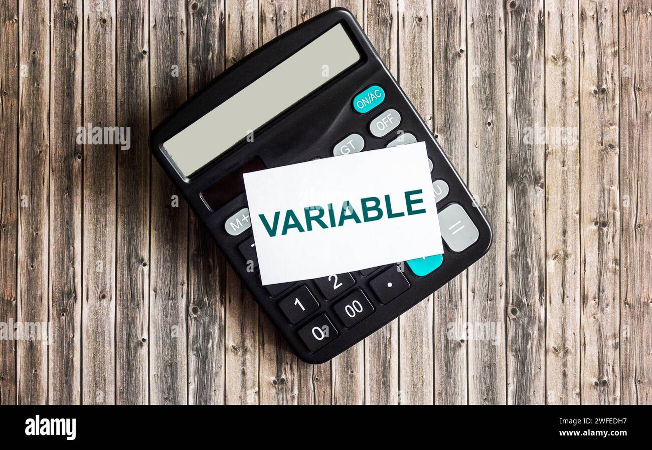 text The variable is written on a sticky note placed on the calculator. Variable universal life insurance. Stock Photo