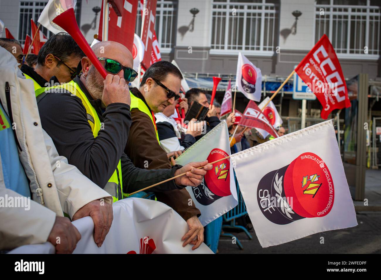 Madrid, Spain. 30th Jan, 2024. Railway protesters hold flags during the rally in front of the Congress of Deputies. The workers' union, Comisiones Obreras, has called a rally in front of the Congress of Deputies to demand the unblocking of the agreements on the elimination of entry categories in Renfe (National Network of Spanish Railways) and on the implementation of the 35-hour day in Adif (railway infrastructure administrator) Credit: SOPA Images Limited/Alamy Live News Stock Photo