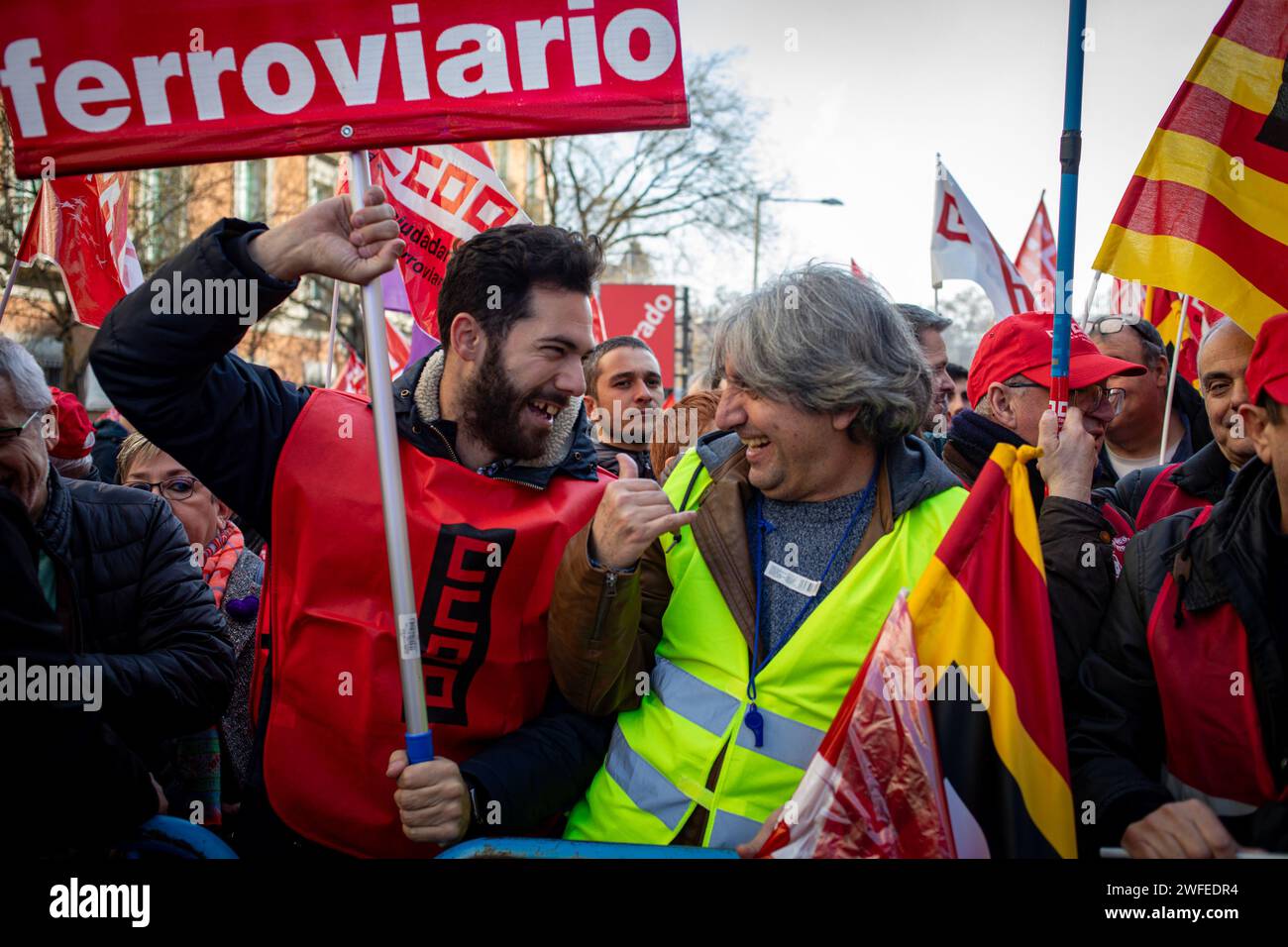 Madrid, Spain. 30th Jan, 2024. A couple of railway employees hold banners and flags during the rally in front of the Congress of Deputies. The workers' union, Comisiones Obreras, has called a rally in front of the Congress of Deputies to demand the unblocking of the agreements on the elimination of entry categories in Renfe (National Network of Spanish Railways) and on the implementation of the 35-hour day in Adif (railway infrastructure administrator) Credit: SOPA Images Limited/Alamy Live News Stock Photo