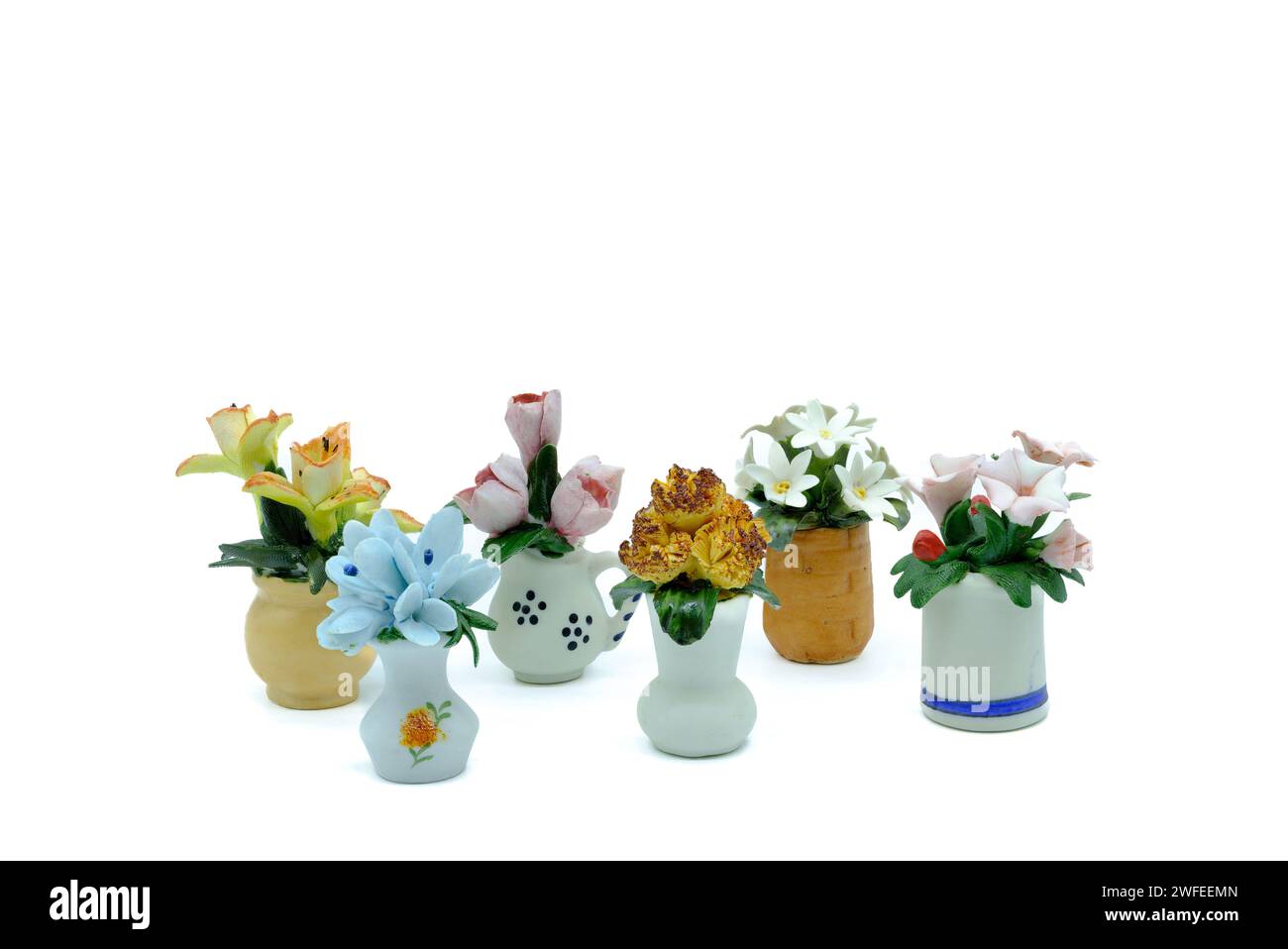 Antique Miniature Flower Ornaments bone china in the shape of baskets jugs and vases of different colours of flowers. Stock Photo