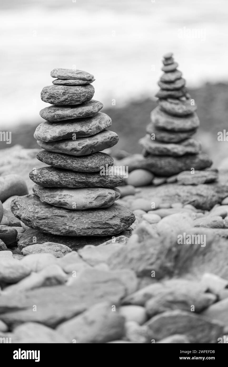 Close up of two towers of pebbles stacked up on a pebble beach Stock Photo