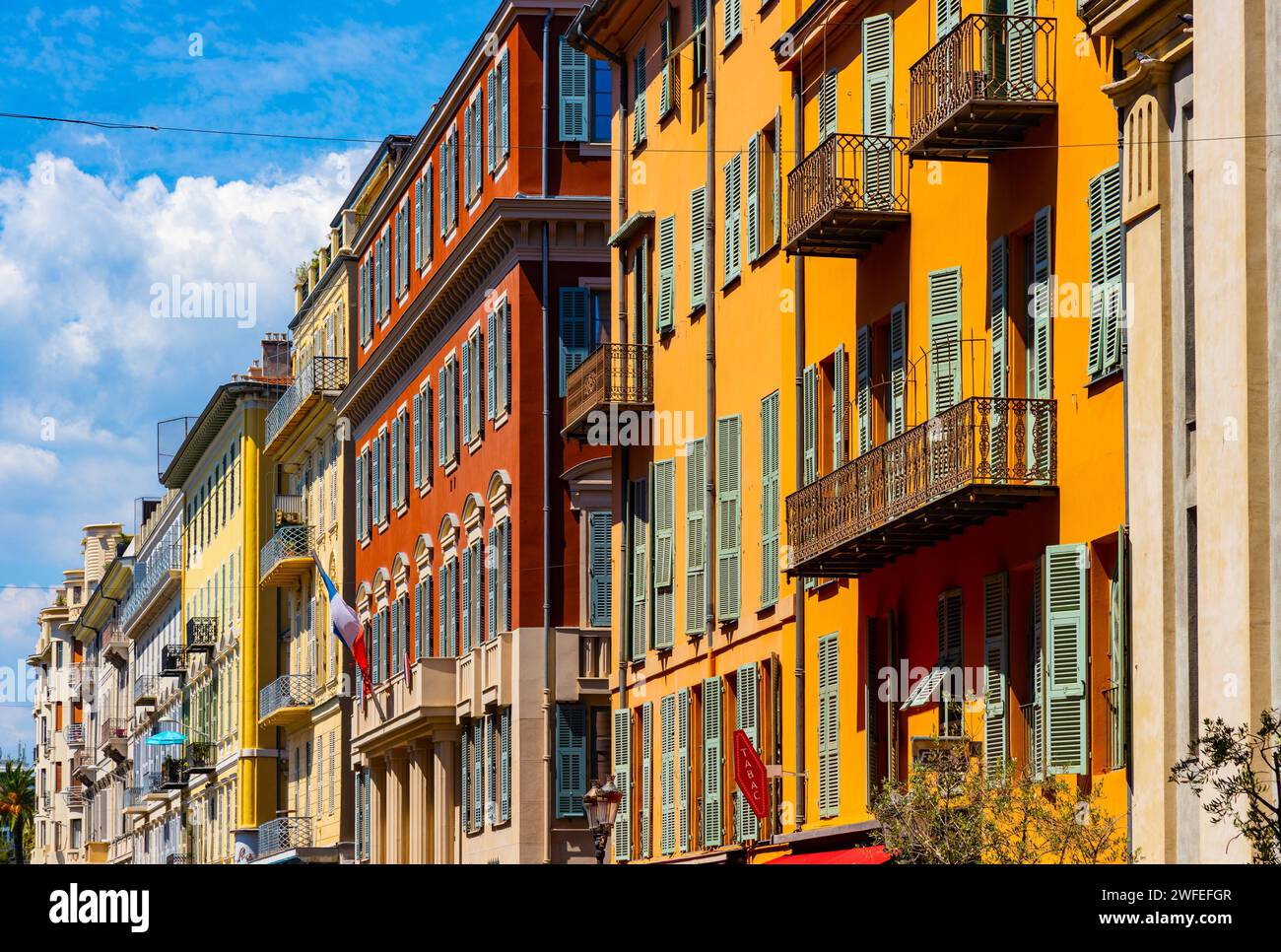 Nice, France - August 7, 2022: Colorful tenement houses along Rue Saint Francois de Paule street in historic Vieux Vieille Ville old town of Nice on F Stock Photo