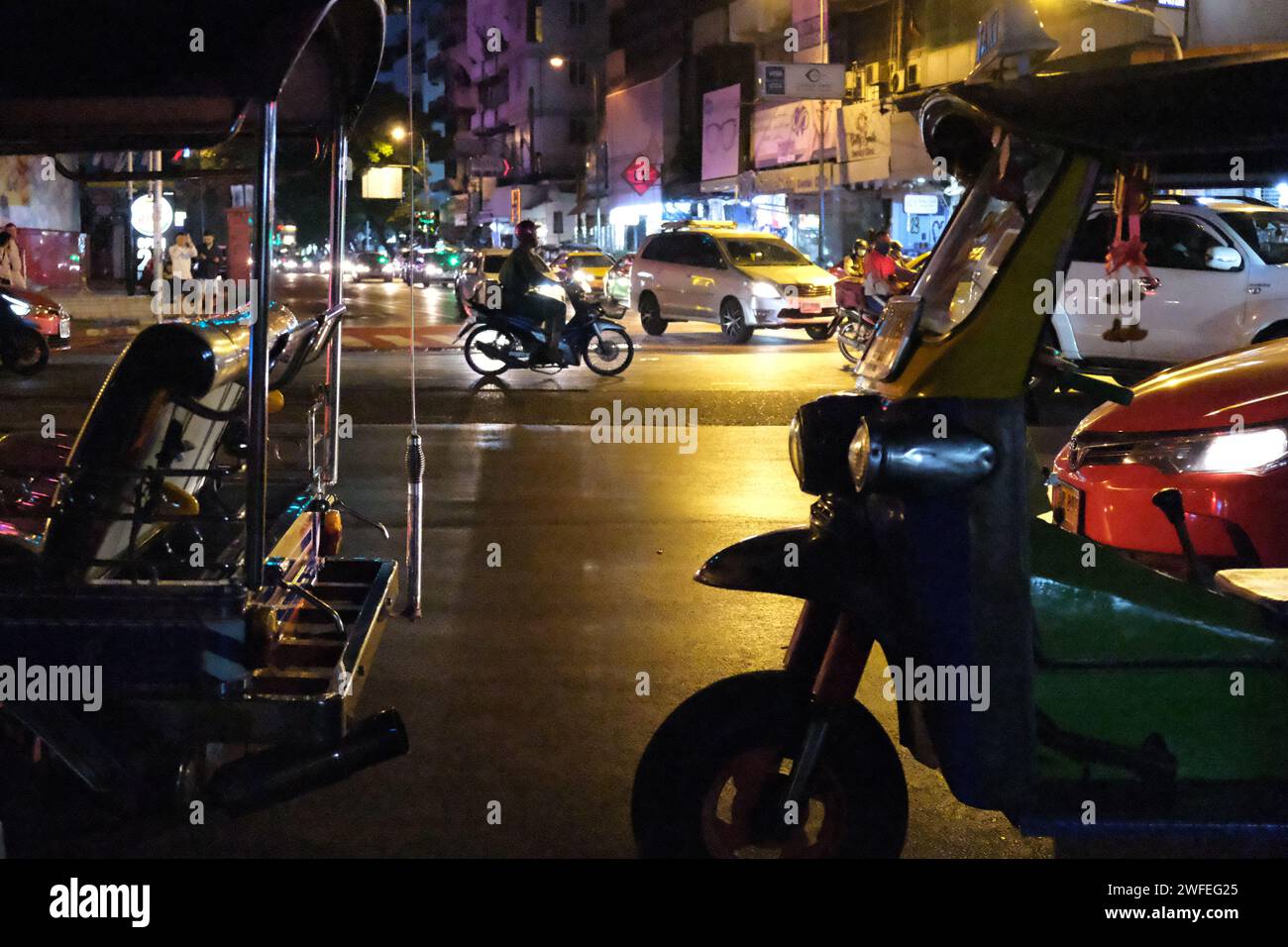 Parked tuktuks on Sukhumvit at night, Bangkok, Thailand Stock Photo