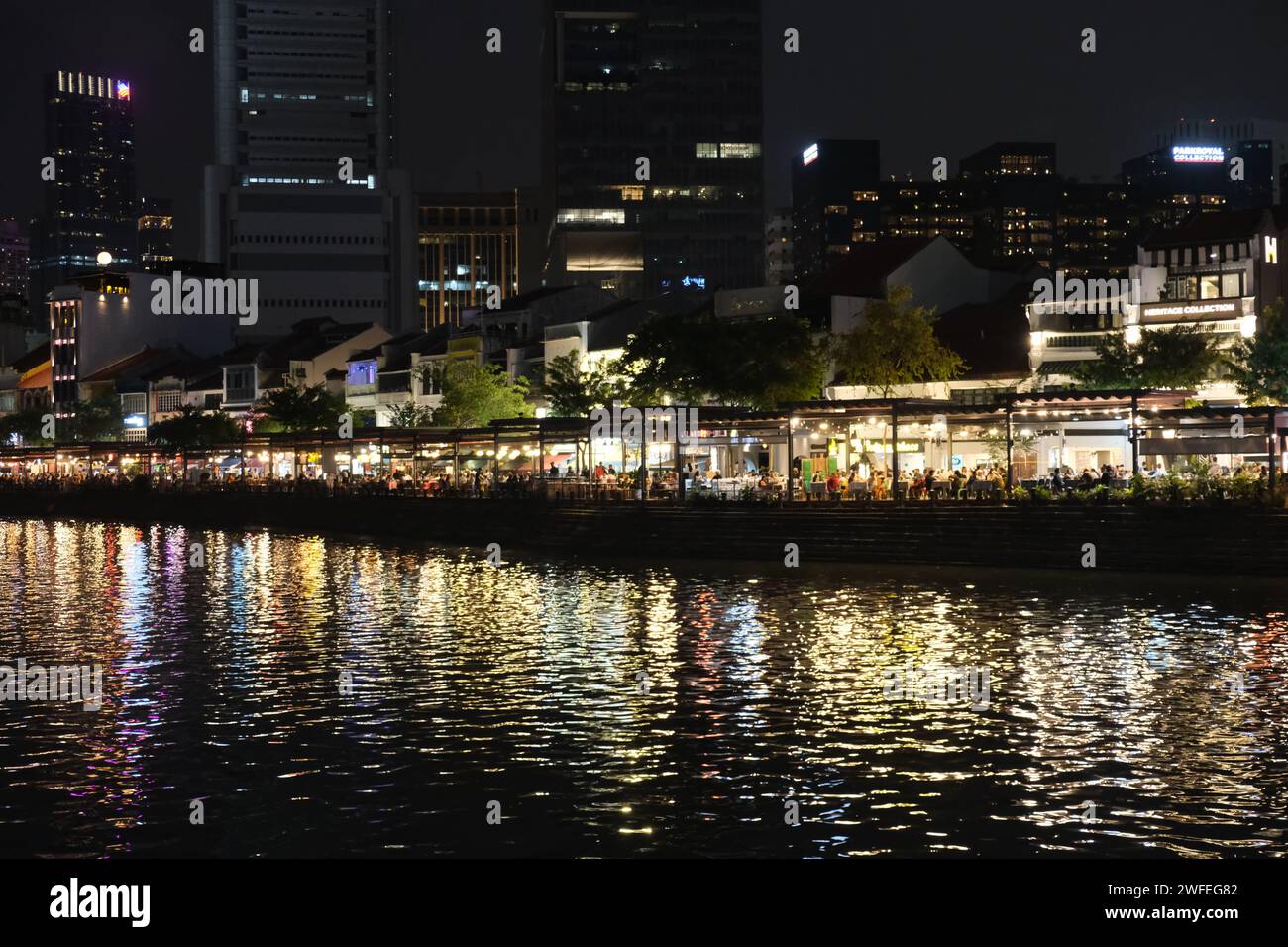 People enjoying the nightlife in riverside bars in Boat Quay in