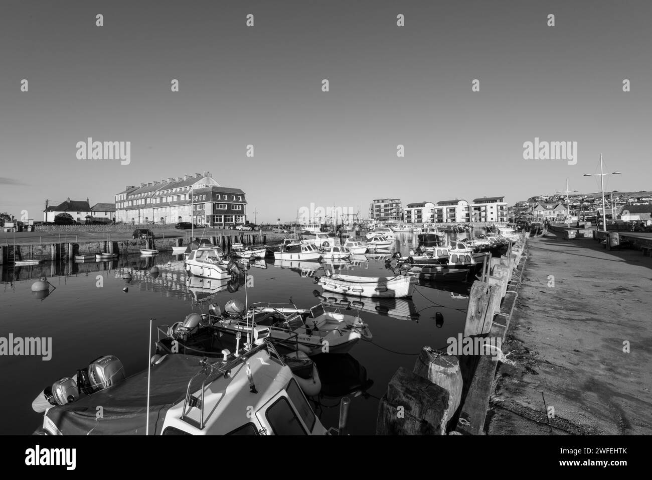Fishing boats moored in West Bay harbour in Dorset Stock Photo - Alamy