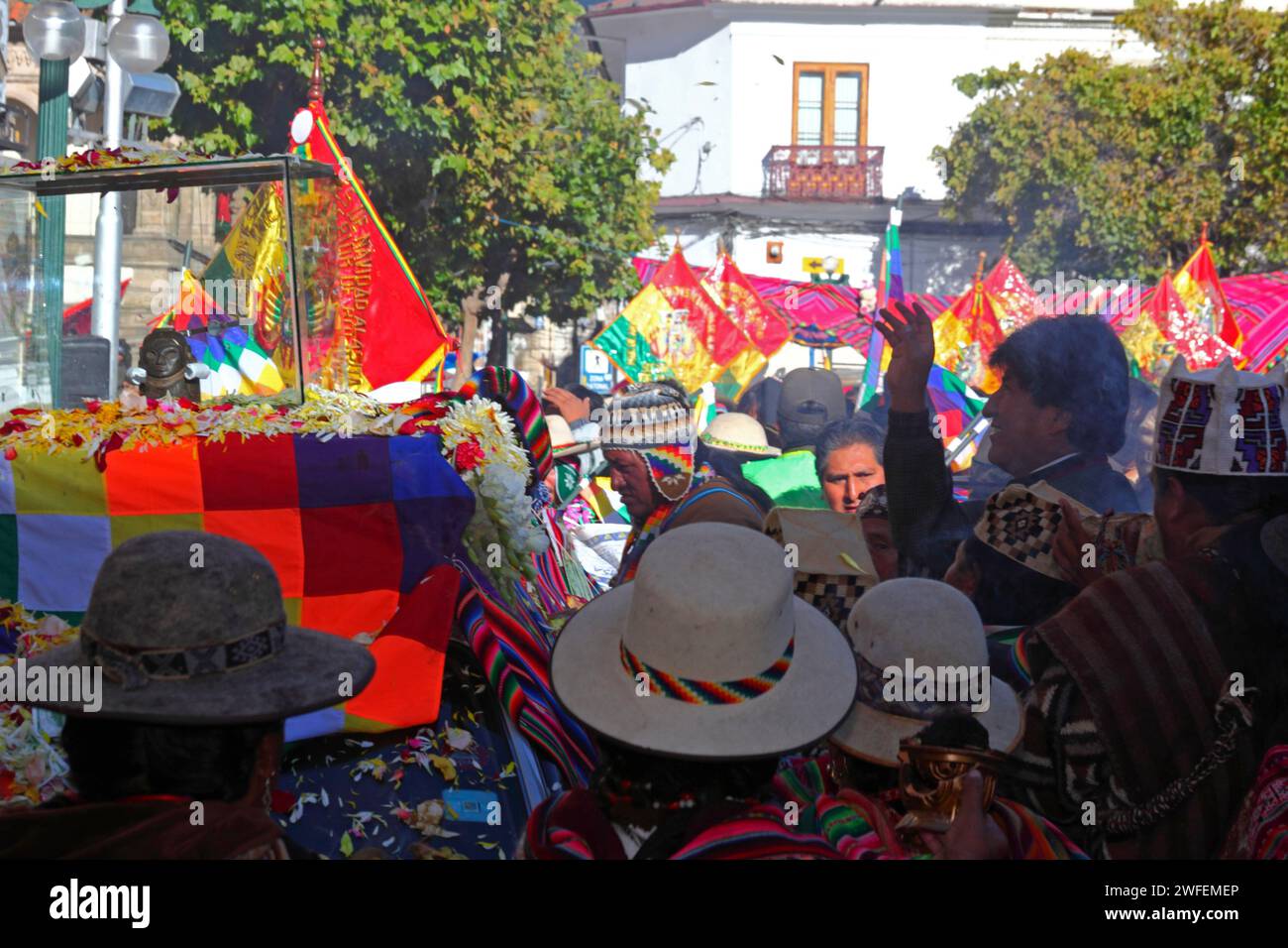 La Paz, BOLIVIA; 24th January 2015. Bolivian president Evo Morales (right, silhouetted) throws petals over an ancient illa (or statue) of an Ekeko (an Aymara god of abundance) as it is paraded through the streets of La Paz to celebrate its first appearance at the Alasitas festival, which starts today. The statue is around 2000 years old and was made by the Pucara culture. It was taken from the archaeological site of Tiwanaku to Switzerland in 1858, and returned to Bolivia by the Berne History Museum in November 2014. Stock Photo