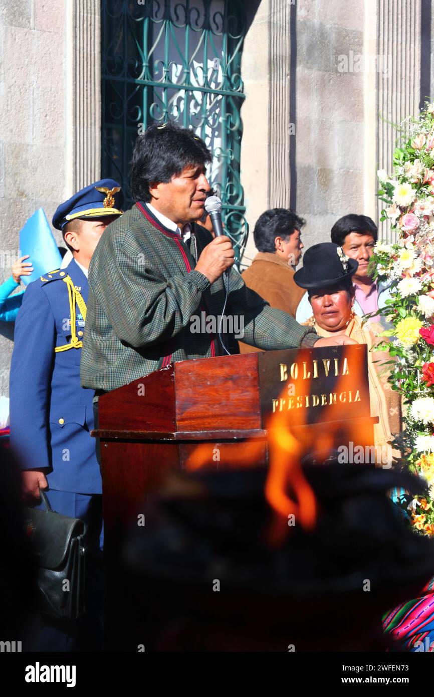 La Paz, BOLIVIA; 24th January 2015. Bolivian president Evo Morales is seen through the flames of an indigenous shaman's incense burner as he makes a speech at an event outside the Presidential Palace at the start of the Alasitas festival in La Paz. Stock Photo