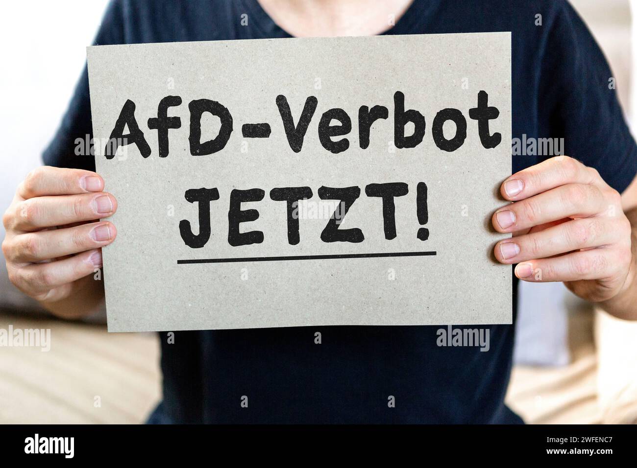 January 30, 2024: Man holding a demo poster with the inscription: AfD ban NOW Symbolic image protest against the Alternative for Germany party PHOTO ASSEMBLY *** Mann hält ein Demo Plakat in der Hand mit der Aufschrift: AfD-Verbot JETZT Symbolbild Protest gegen die Partei Alternative für Deutschland FOTOMONTAGE Stock Photo