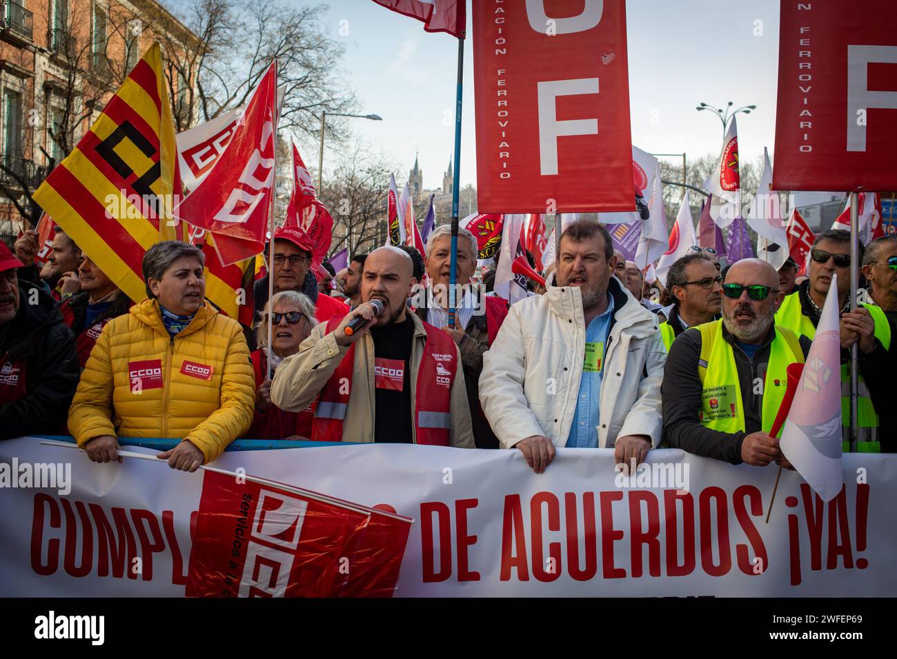 Madrid, Spain. 30th Jan, 2024. Railway protesters carry a banner while others carry flags during the rally in front of the Congress of Deputies. The workers' union, Comisiones Obreras, has called a rally in front of the Congress of Deputies to demand the unblocking of the agreements on the elimination of entry categories in Renfe (National Network of Spanish Railways) and on the implementation of the 35-hour day in Adif (railway infrastructure administrator) (Photo by David Canales/SOPA Images/Sipa USA) Credit: Sipa USA/Alamy Live News Stock Photo