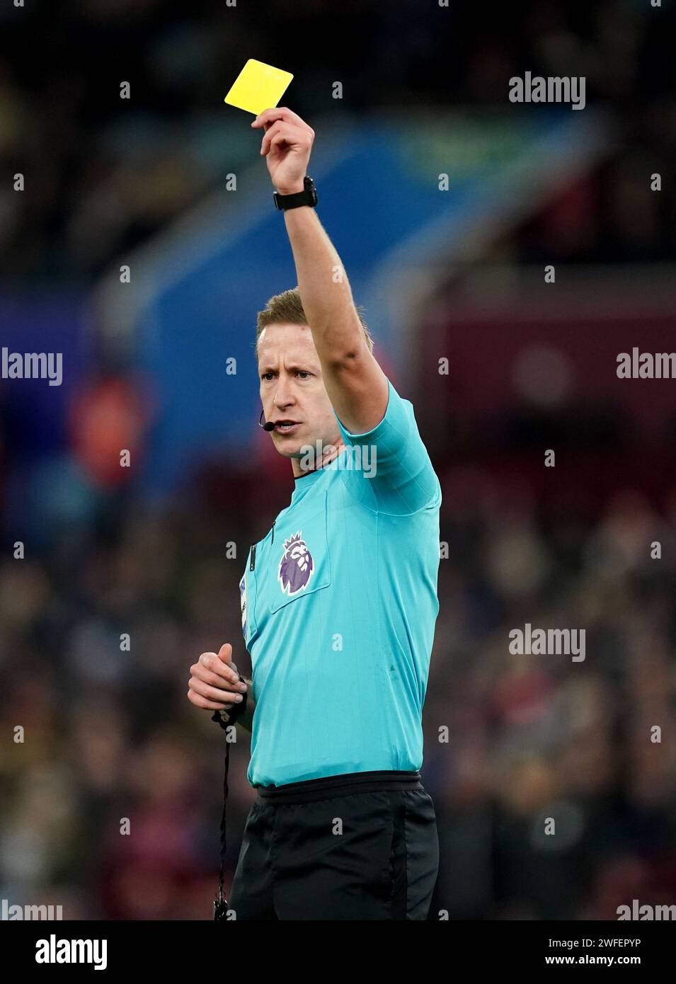 Referee John Brooks shows a yellow card during the Premier League match