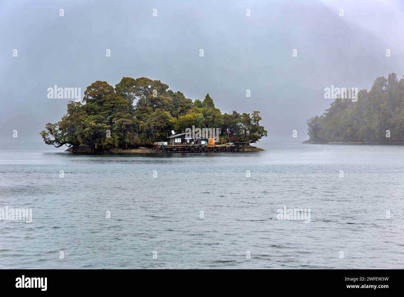 Blanket Bay Hotel, a commercial fishing resupply and refueling depot located on a small island at the head of Doubtful Sound / Patea, Fiordland /Te Ru Stock Photo