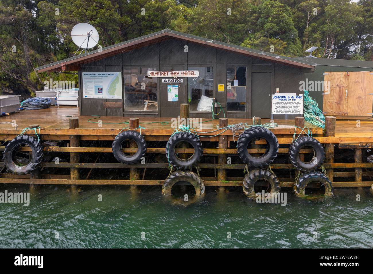Rainy day at the Blanket Bay Hotel, a commercial fishing resupply and refueling depot located at Doubtful Sound, Fiordland, New Zealand, South Island Stock Photo