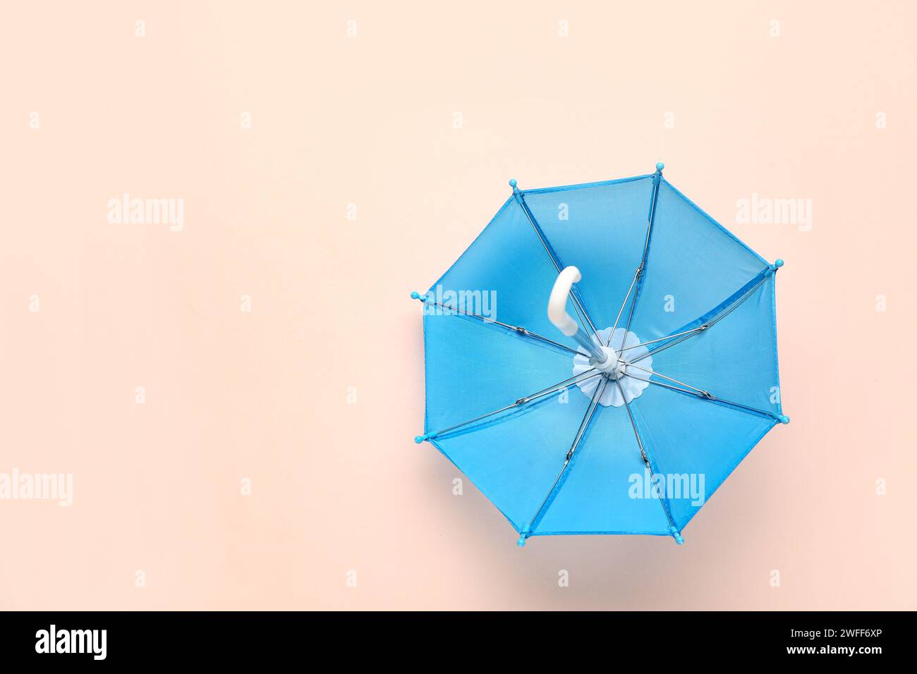 Mini stylish umbrella on beige background Stock Photo