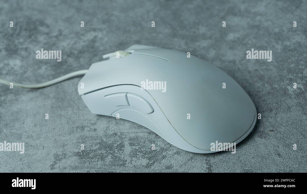 White PC mouse on a gray background with concrete texture Stock Photo