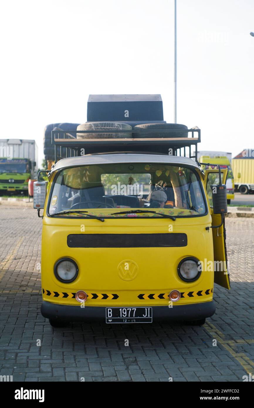 Yellow Volkswagen kombi or bus parked in the side road Stock Photo