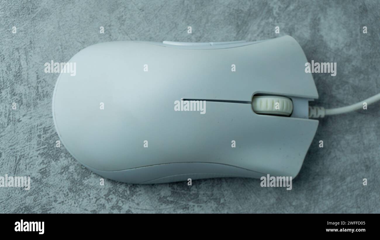 White PC mouse on a gray background with concrete texture Stock Photo