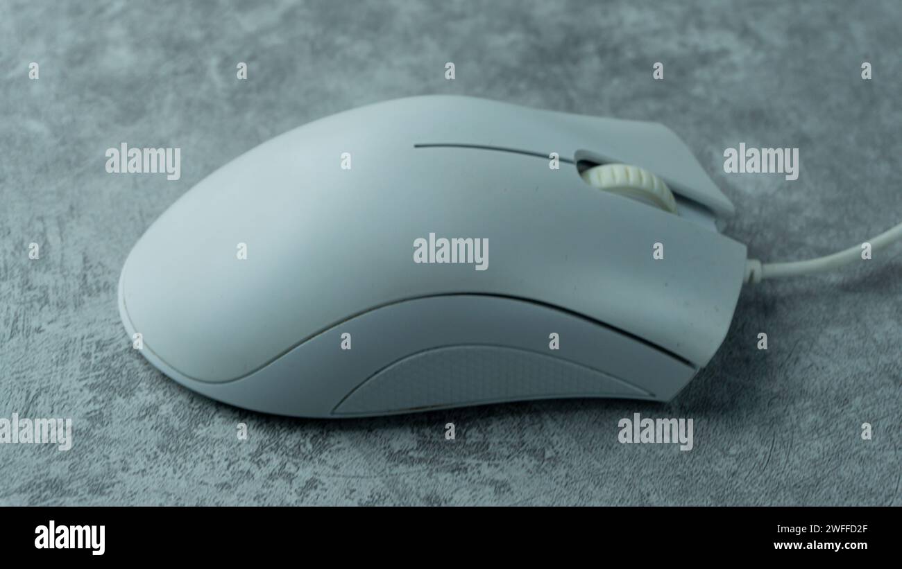White PC mouse on a gray background with concrete texture Stock Photo