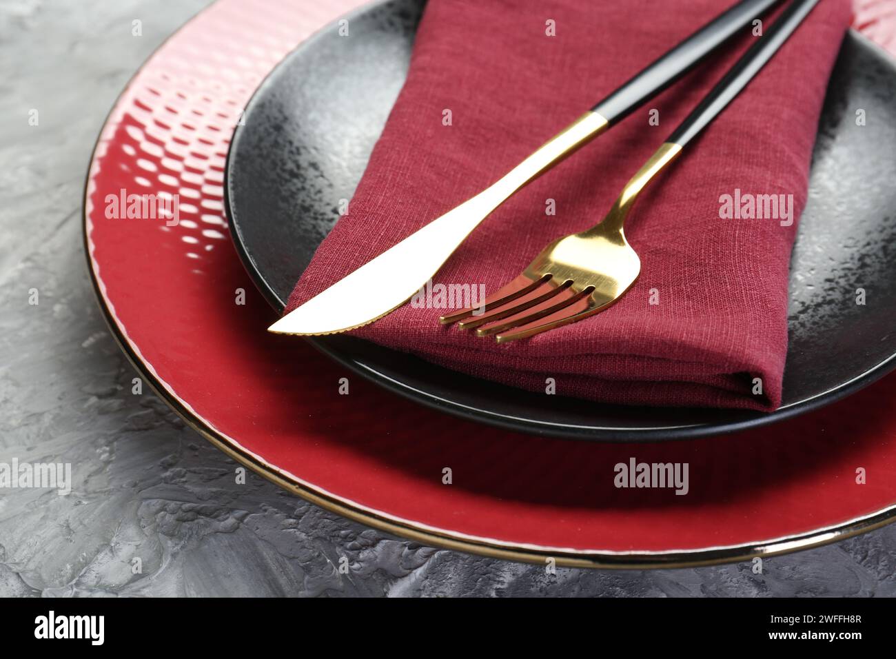 Clean plates, cutlery and napkin on table, closeup Stock Photo