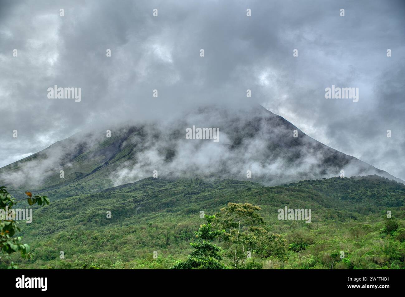 Amazing view of beautiful nature of Costa Rica with smoking volcano Arenal background. Panorama of volcano Arenal La Fortuna, Costa Rica. Central Amer Stock Photo