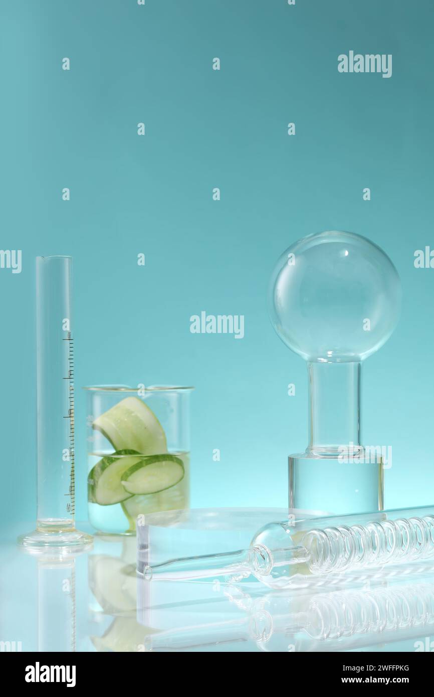A condenser, volumetric cylinder and a beaker with Cucumber slices ...