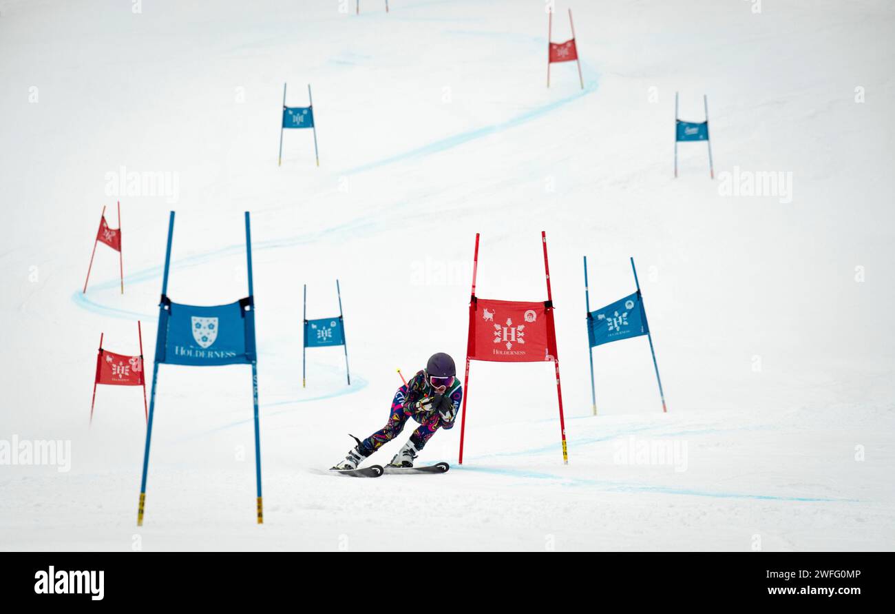 U18 female skier on the giant slalom course during a 2024 Macomber Cup series race at the Franconia ski club at Cannon Mountain in Franconia, New Hampshire. Stock Photo