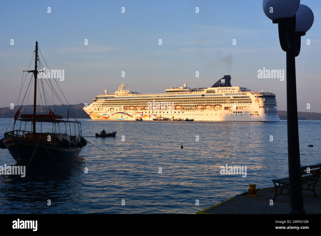 The large cruise ship Norwegian Star tendering passengers to Santorini Greece from the bay. Stock Photo