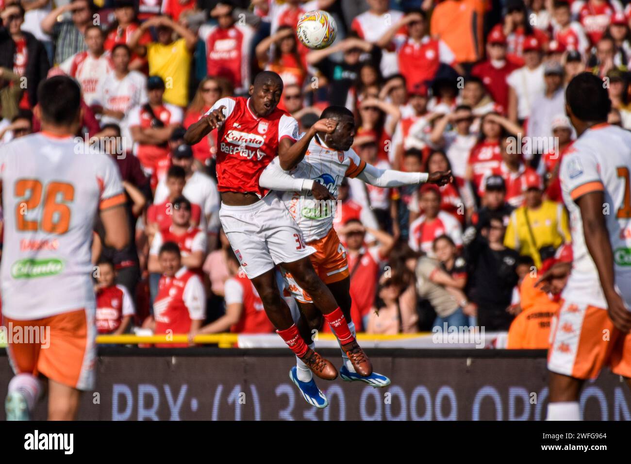Bogota, Colombia. 27th Jan, 2024. Independiente Santa Fe's Dairon Mosquera wins a headshot against Envigado's FC Luis Angel Diaz during the BetPlay Dimayor league match between Independiente Santa Fe (3) vs Envigado FC (1) on January 27, 2024, in Bogota, Colombia. Photo by: Cristian Bayona/Long Visual Press Credit: Long Visual Press/Alamy Live News Stock Photo