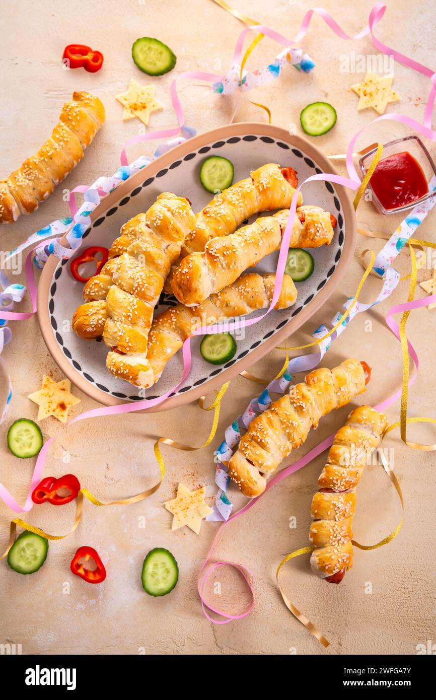 Pig in blanket, long sausages wrapped in yeast dough traditional