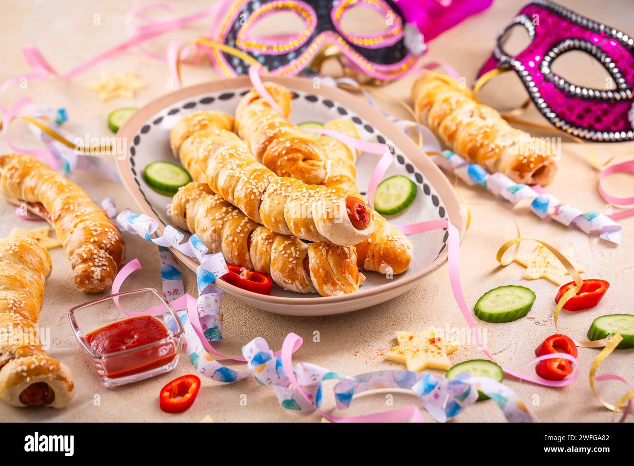 Pig in blanket, long sausages wrapped in yeast dough - traditional carnival, Fasching and party food Stock Photo