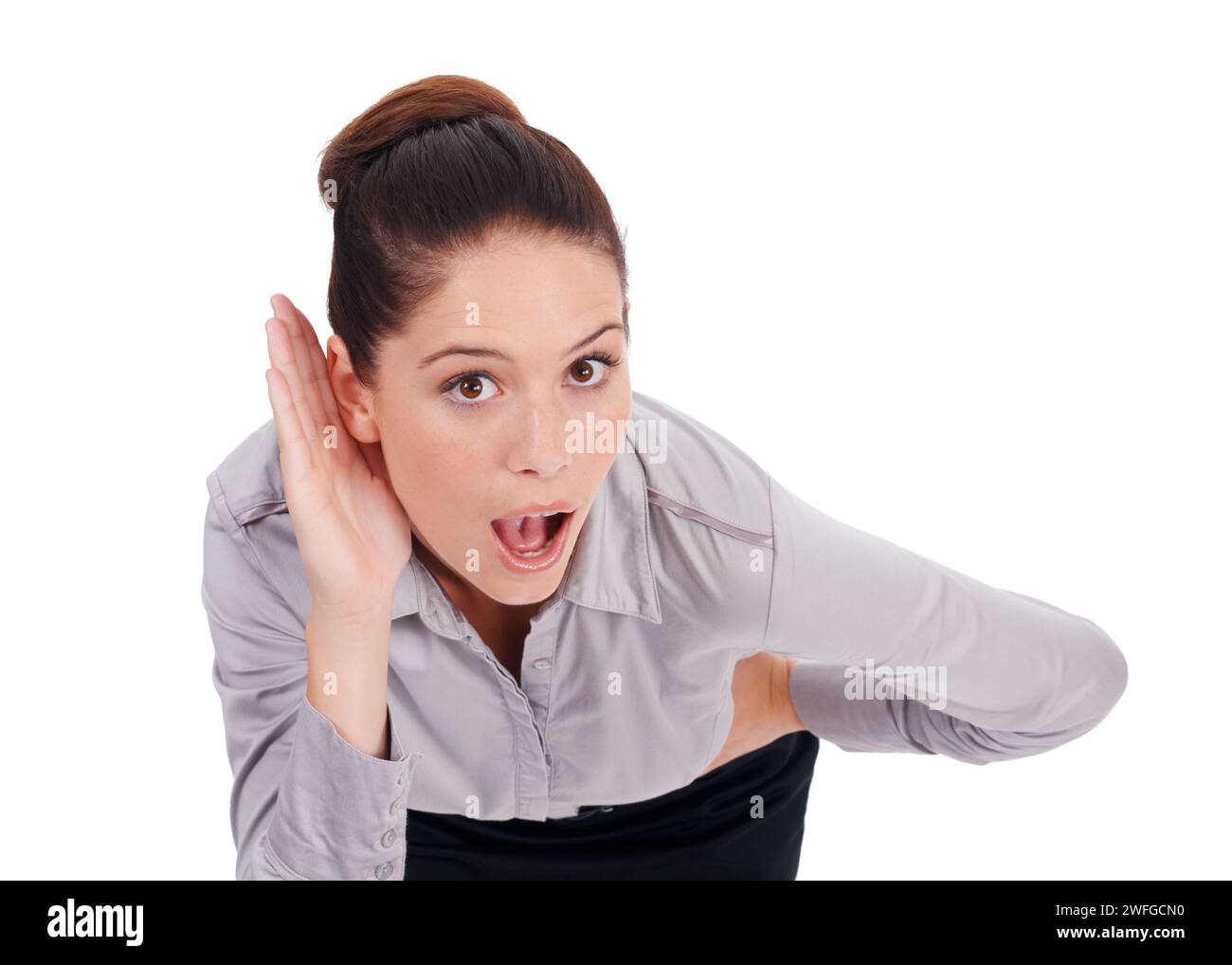 Business woman, listening and wow for gossip, news or confidential intel on a white background. Portrait of young employee with palm or hands cupping Stock Photo