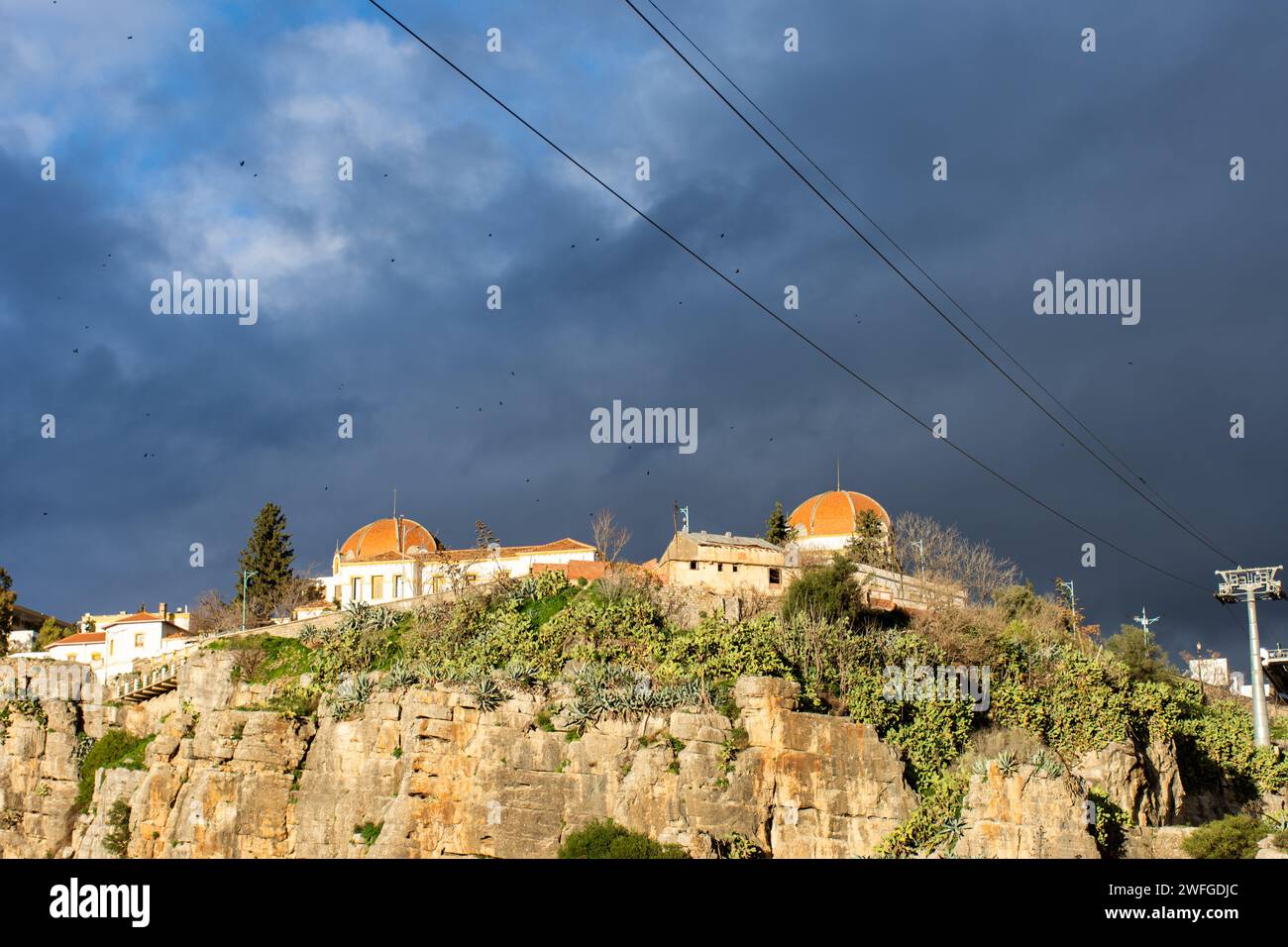 Low-angle view of University Hospital Abdelhamid Ben Badis against a cloudy sky in Constantine City. Stock Photo