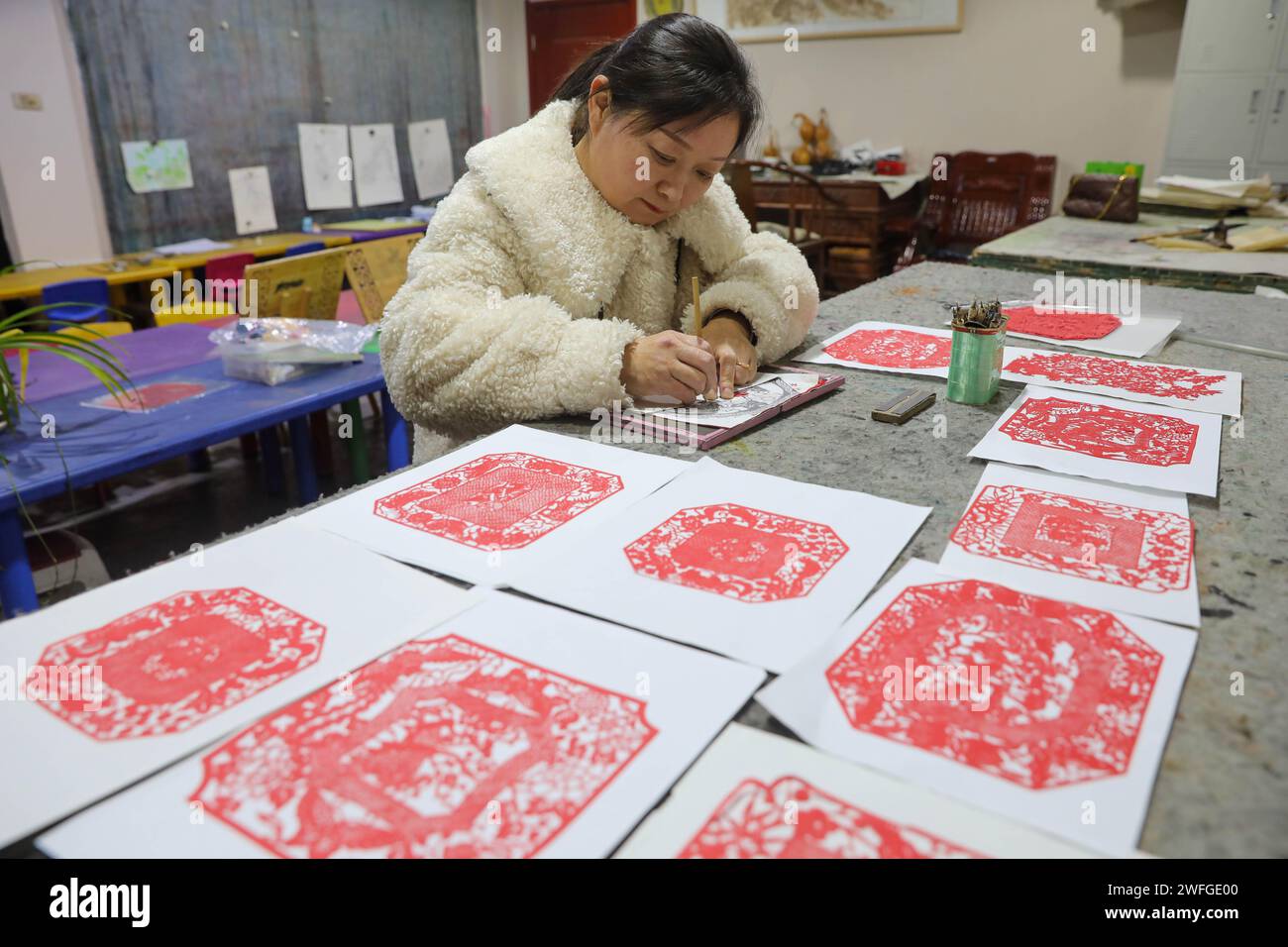 Pingdingshan, China. 31st Jan, 2024. Paper-cutting artist Chen Songge is carving a Spring Festival creation at an art studio in Pingdingshan, China, on January 31, 2024. (Photo by Costfoto/NurPhoto) Credit: NurPhoto SRL/Alamy Live News Stock Photo