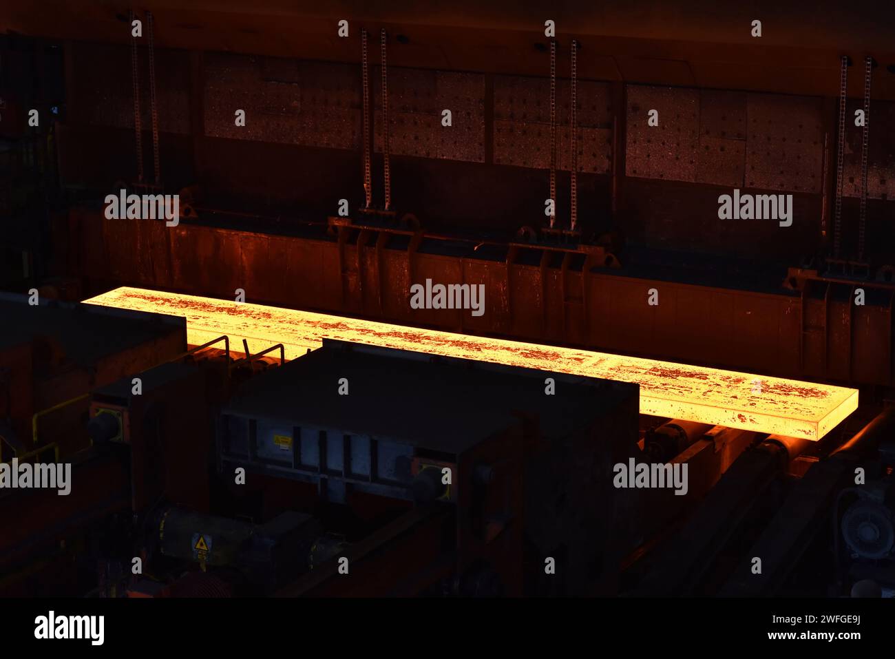 glowing brame in a steel mill - industrial factory for the production of metal sheets Stock Photo