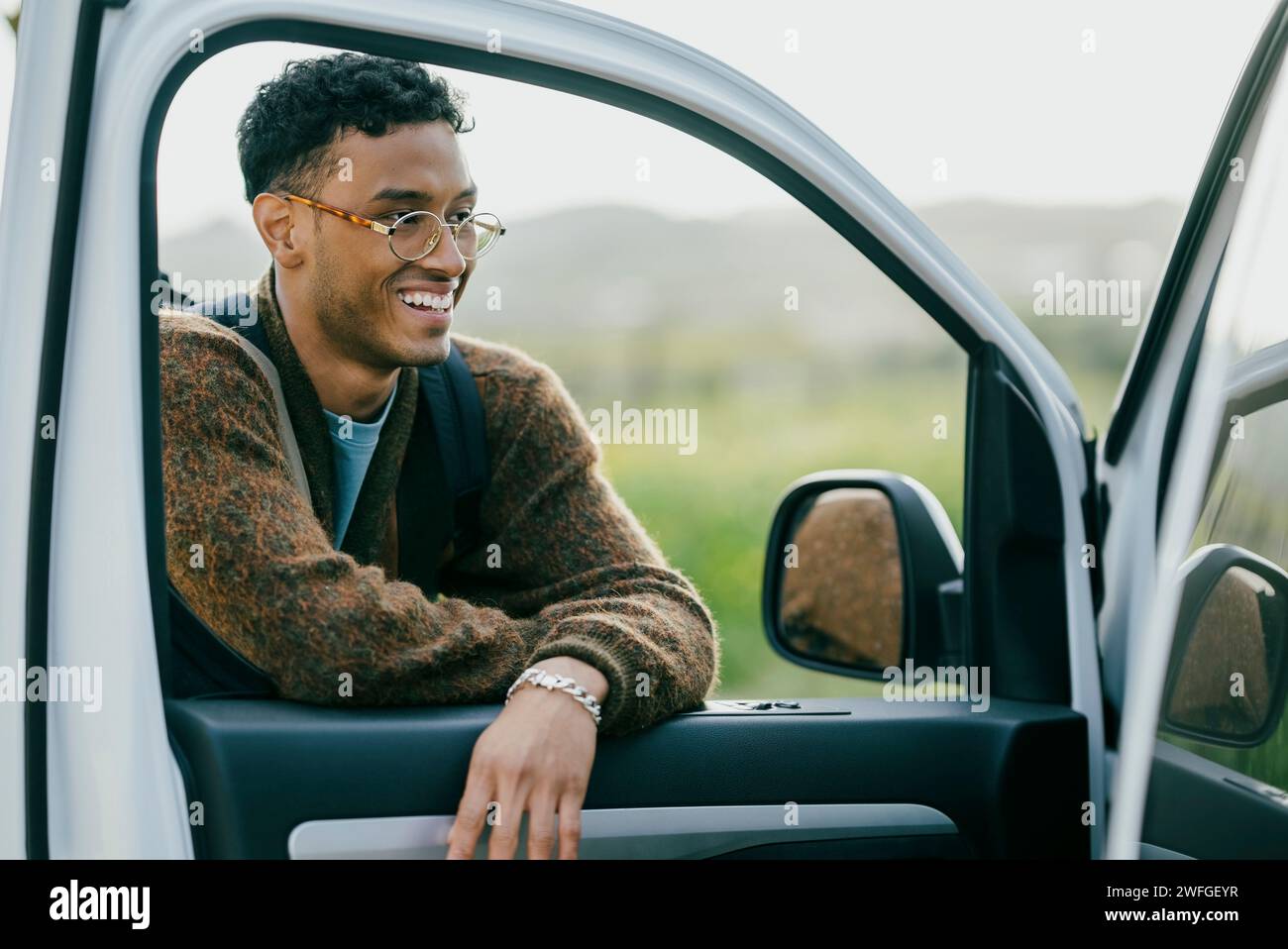 Smiling man leaning on van door Stock Photo
