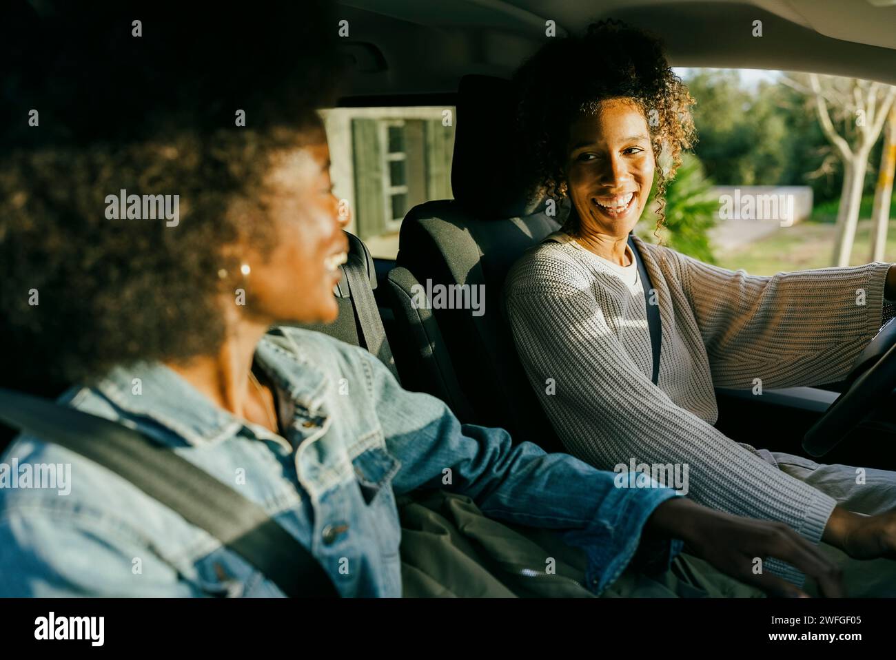 Happy young women sitting in car Stock Photo - Alamy