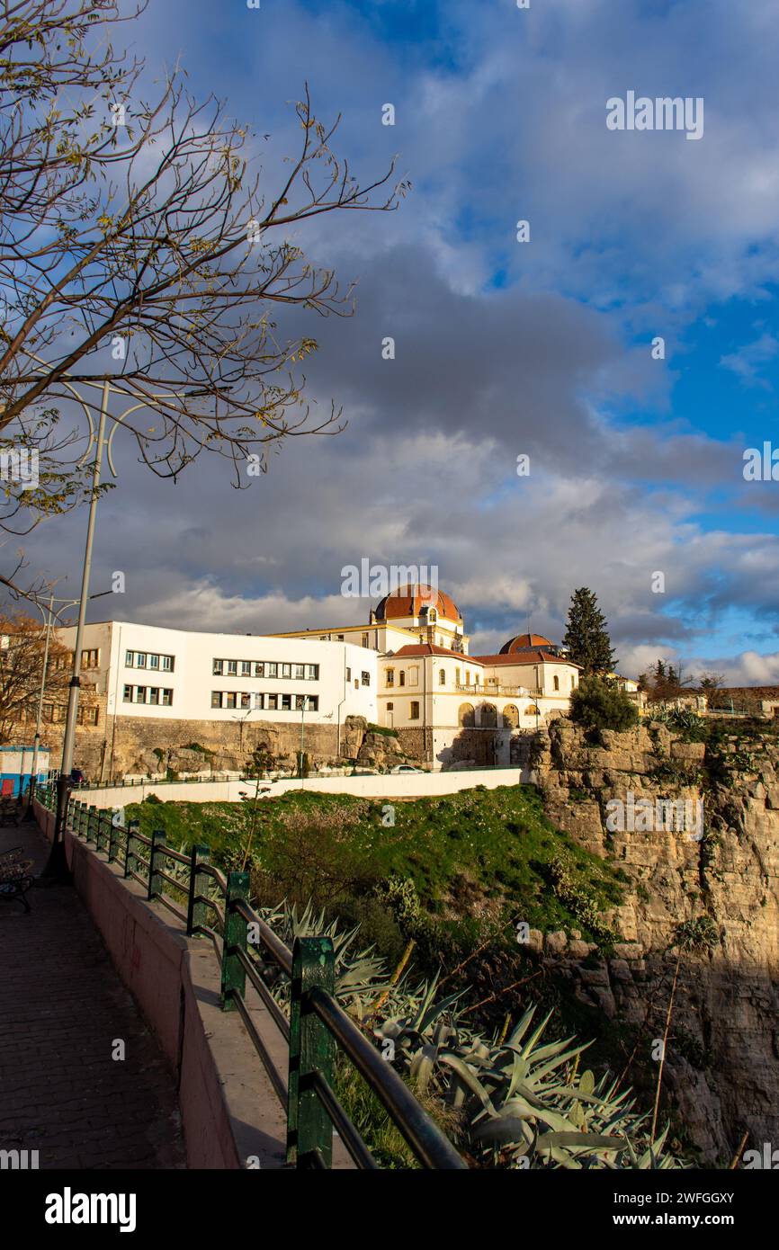 Low-angle view of University Hospital Abdelhamid Ben Badis against a cloudy sky in Constantine City. Stock Photo