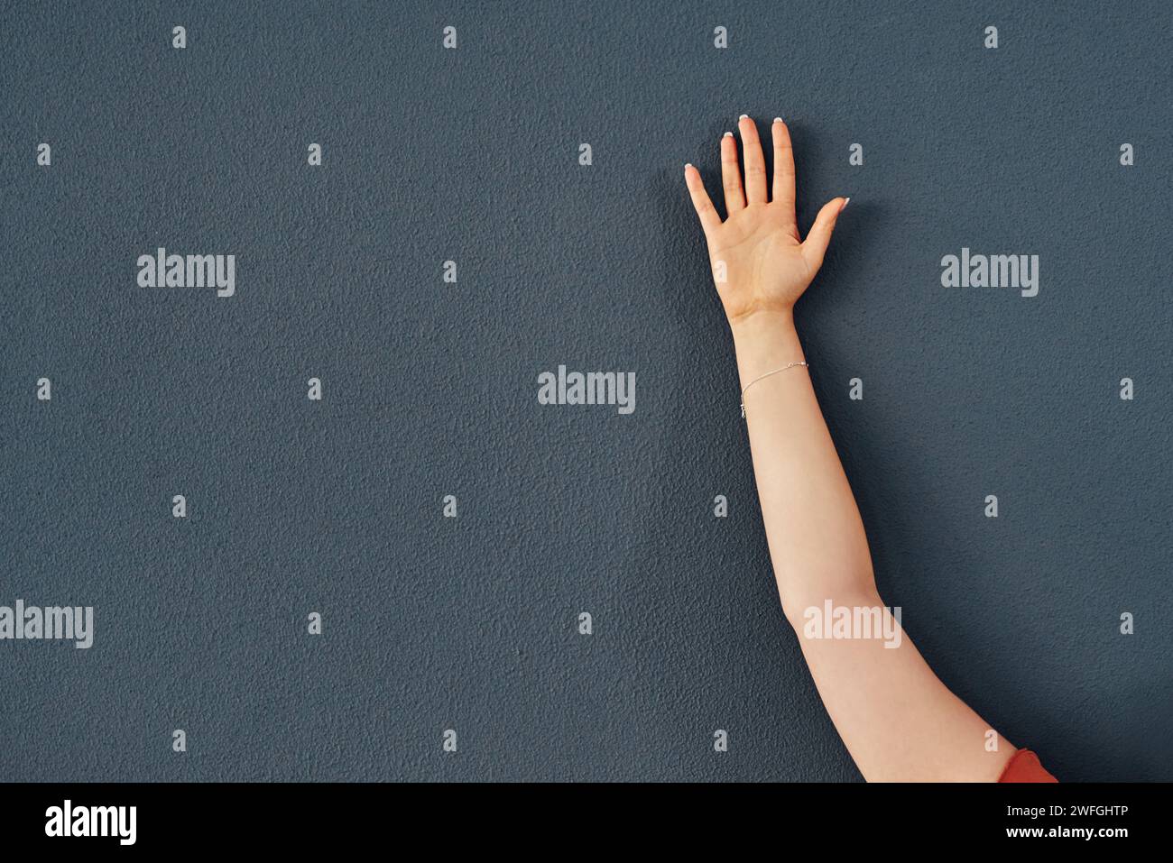 Hand, raise and question asking for education on grey wall background ...
