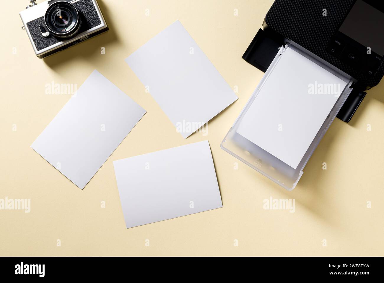 Top view of retro camera, blank photo papers and mobile photo printer Stock Photo