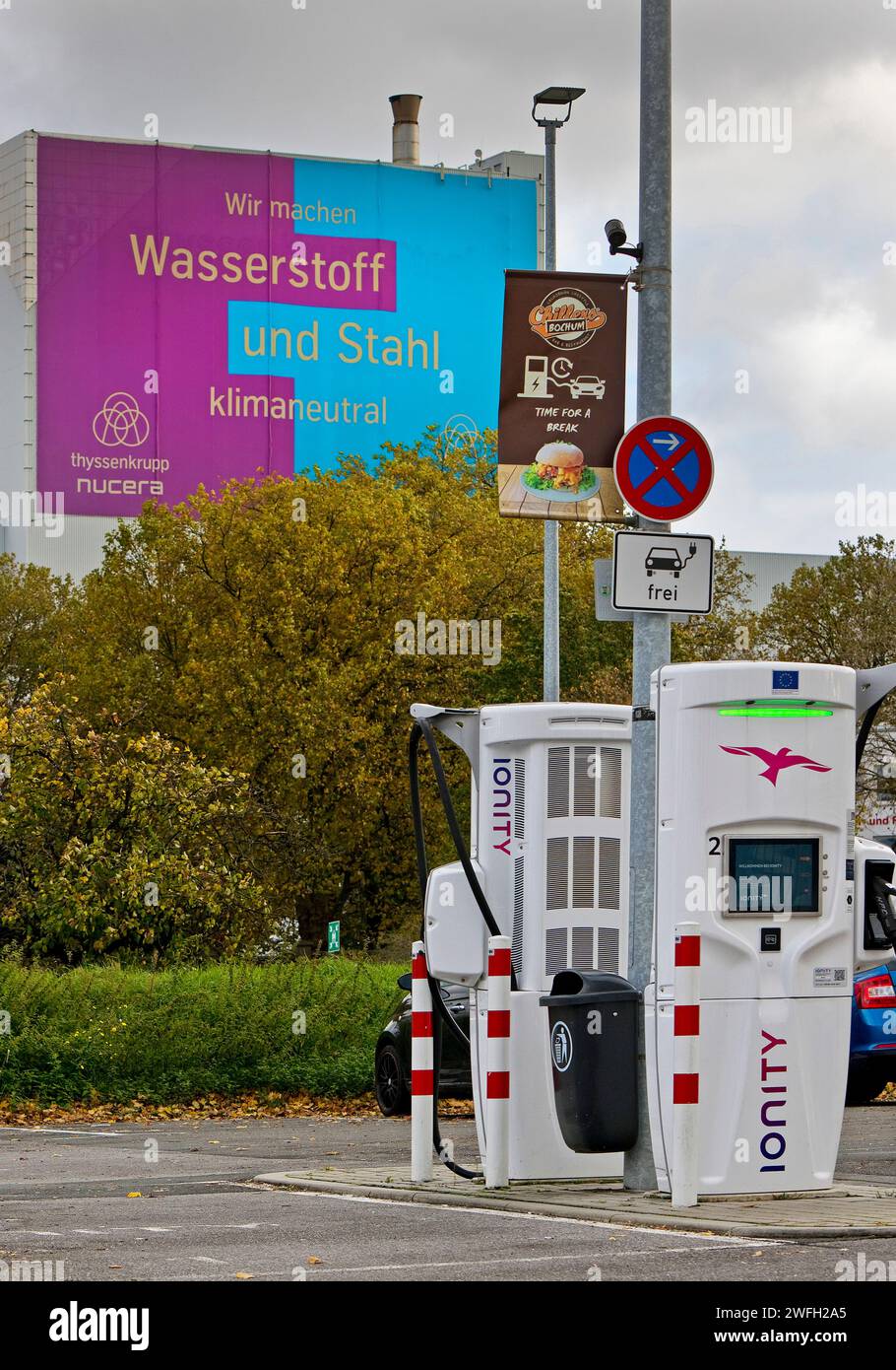 Charging station and large poster for climate steel at the ThyssenKrupp Steel Europe plant, Germany, North Rhine-Westphalia, Ruhr Area, Bochum Stock Photo