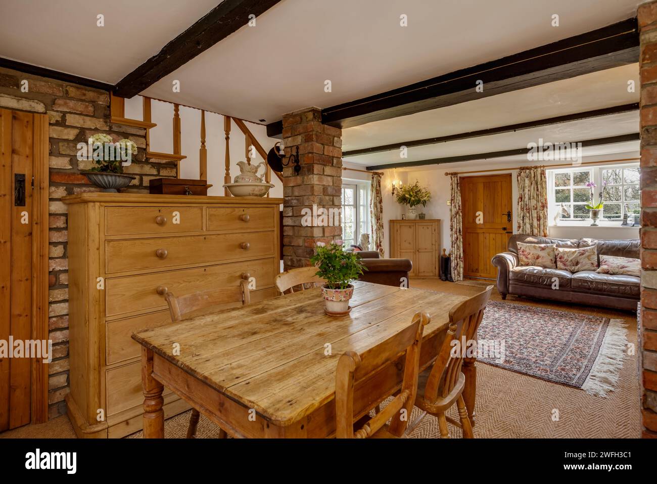 Boxworth, England - March 17 2016: Traditional furnished cottage dining and living room Stock Photo