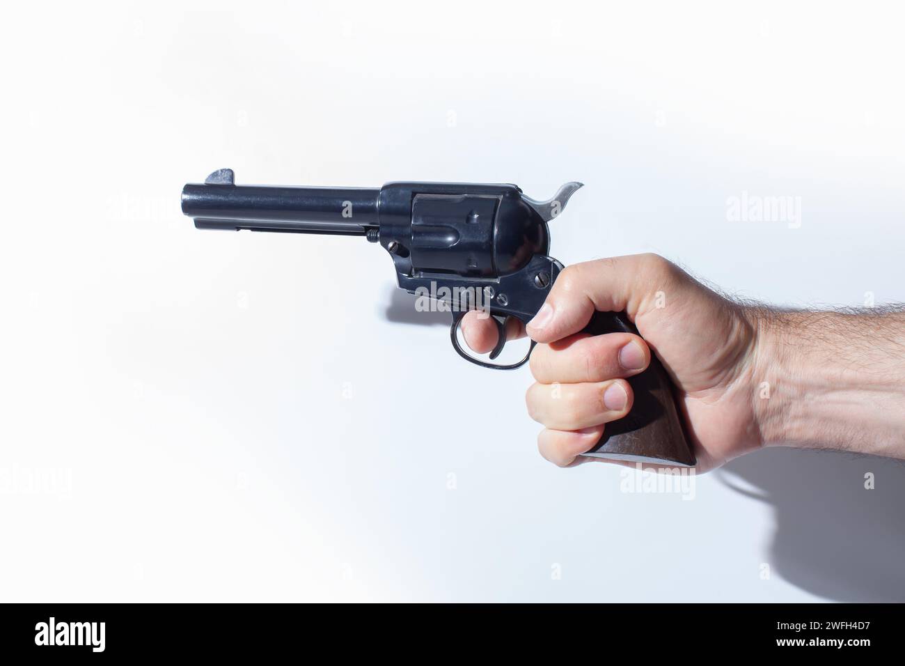 hand holding replica gun isolated on white background Stock Photo