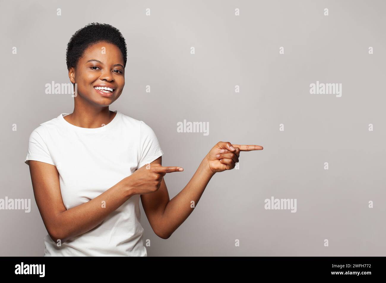 Excited woman pointing finger hi-res stock photography and images - Alamy