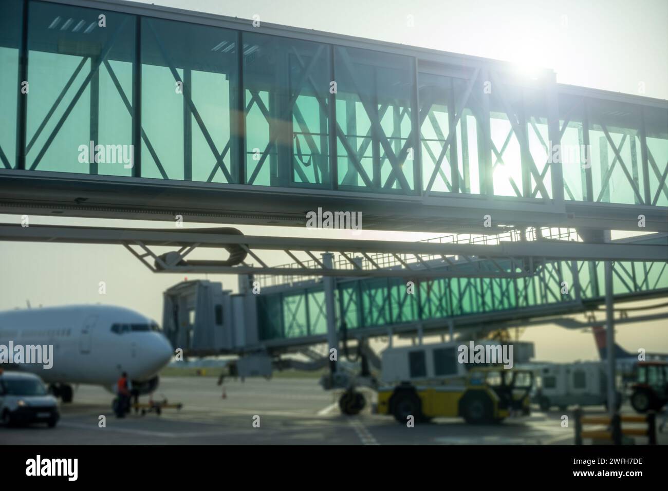airport glass walkway leading to airplane Stock Photo Alamy