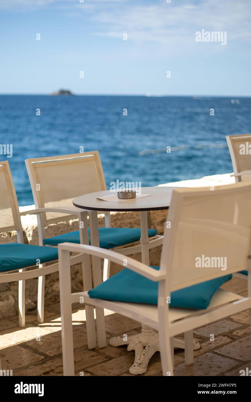 close up of table setting at open-air cafe on beach Stock Photo