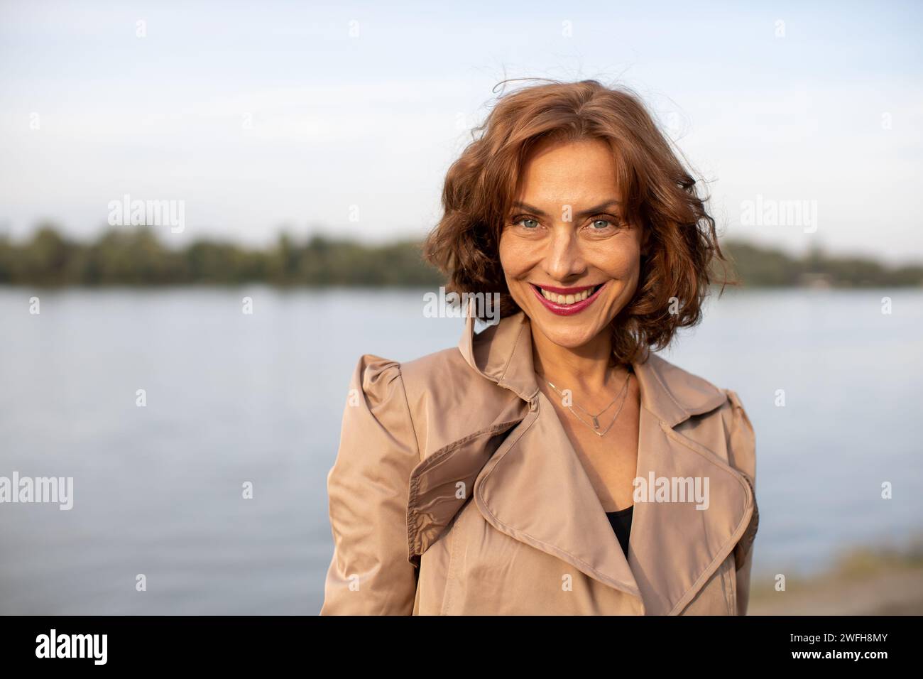 woman enjoying a beautiful autumn day by the river Stock Photo