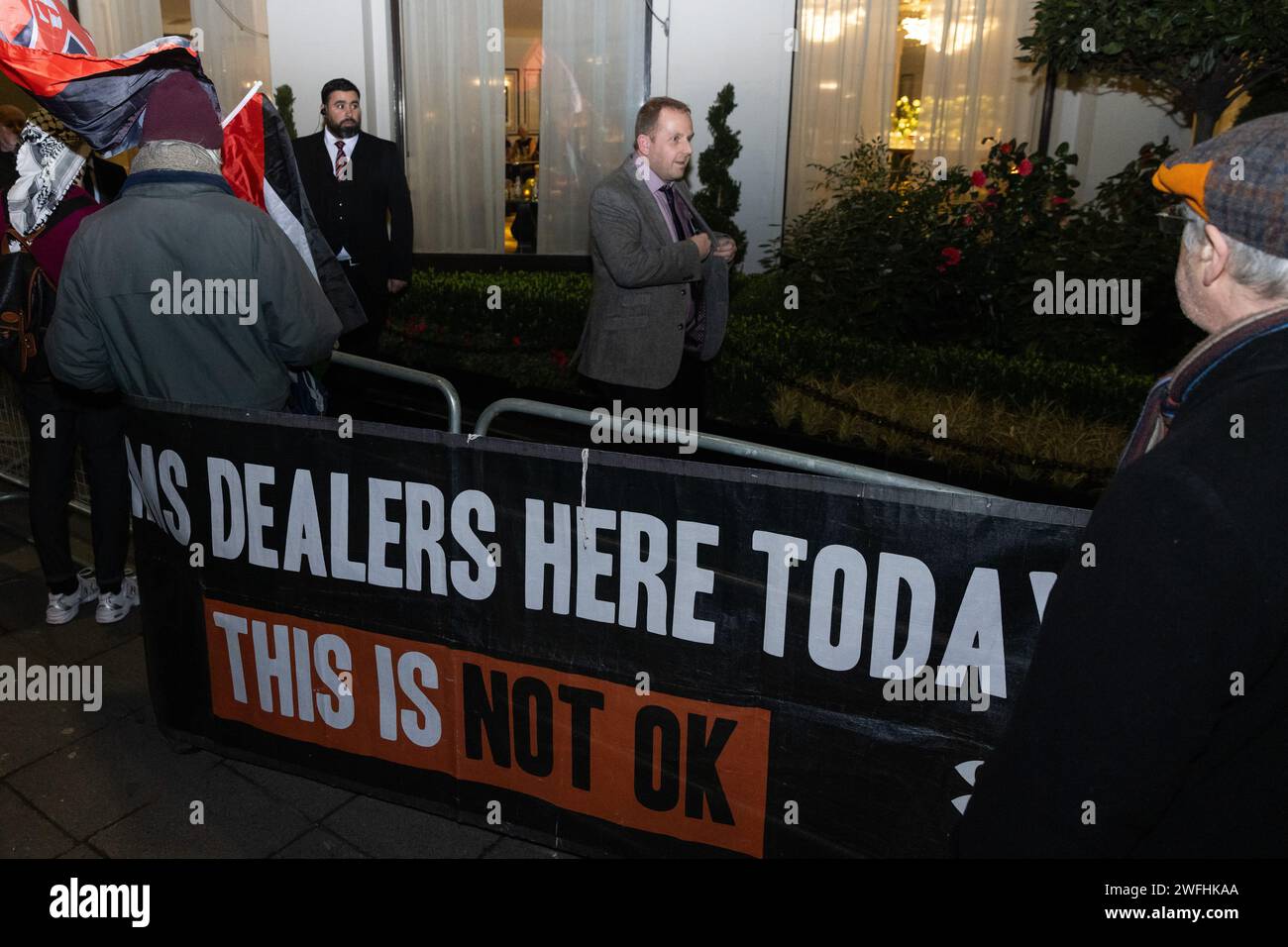 London, UK. 30th January, 2024. Guests arriving at the JW Marriott Grosvenor House Hotel for the ADS Annual Dinner encounter a protest by campaigners against the arms trade. The ADS Annual Dinner brings together representatives of companies from the UK's aerospace, defence, security and space industries. Sponsors of the event include BAE Systems which supplies components for F-35 combat aircraft used by Israel during its invasion of Gaza. Credit: Mark Kerrison/Alamy Live News Stock Photo