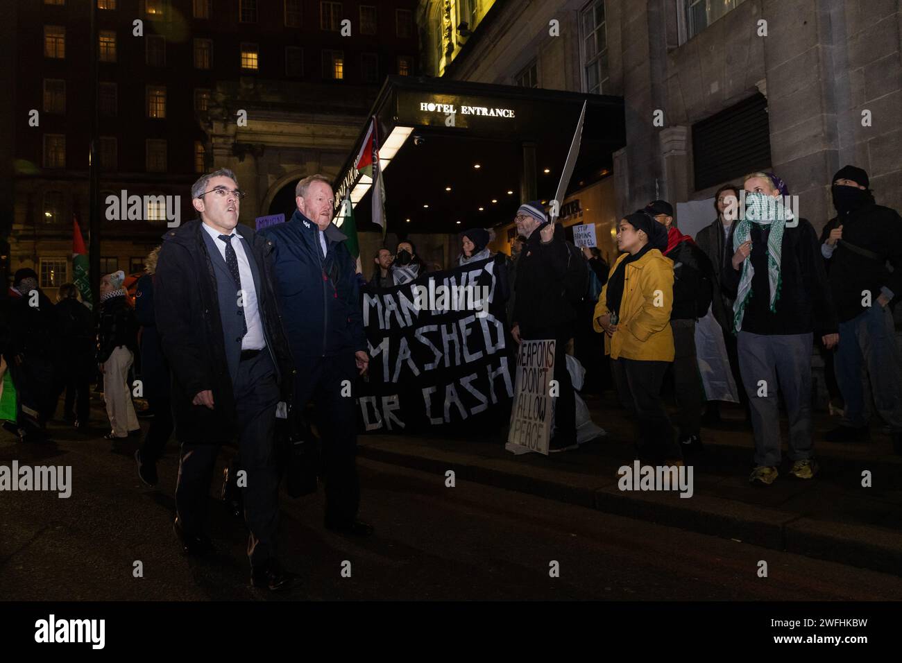 London, UK. 30th January, 2024. Guests arriving at the JW Marriott Grosvenor House Hotel for the ADS Annual Dinner encounter a protest by campaigners against the arms trade. The ADS Annual Dinner brings together representatives of companies from the UK's aerospace, defence, security and space industries. Sponsors of the event include BAE Systems which supplies components for F-35 combat aircraft used by Israel during its invasion of Gaza. Credit: Mark Kerrison/Alamy Live News Stock Photo